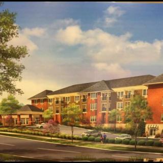 An illustration of a suburban residential building with multiple floors and landscaped surroundings.