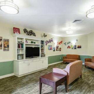 Cozy living room with comfortable seating and wall decorations.