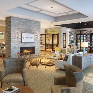 A modern and cozy living room with stylish furniture and a fireplace.