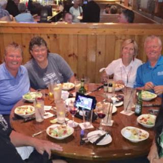 A cheerful gathering of friends enjoying a meal together at a restaurant.