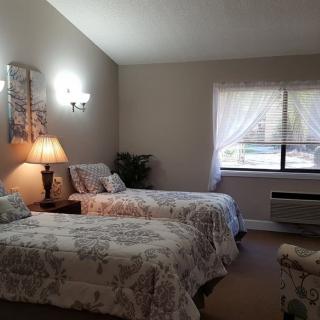 A cozy bedroom with twin beds and a softly lit ambiance.