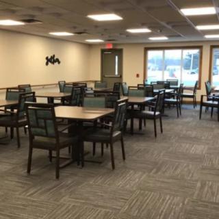 An empty dining area with tables and chairs inside a restaurant.