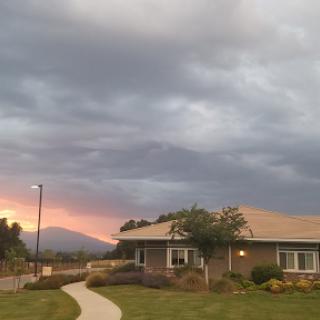 A tranquil moment captured during sunset, showcasing a residential area under a dramatic sky.