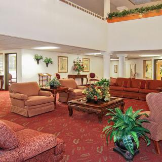A spacious lobby with comfortable seating and plants.