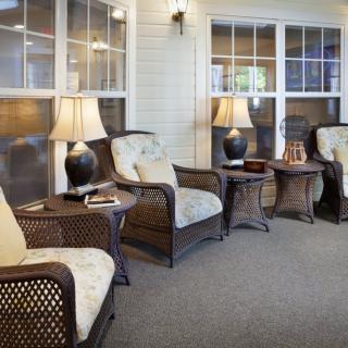 A cozy indoor lounge area with comfortable chairs and lamps.