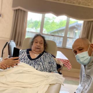 A caregiver takes a moment to connect with a patient in a healthcare setting.
