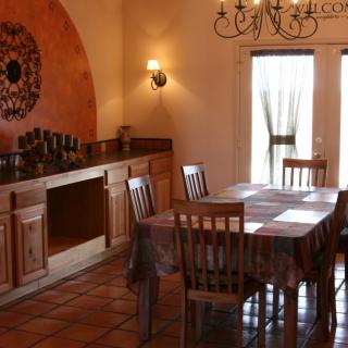 A rustic dining room with wooden furniture and warm decor.