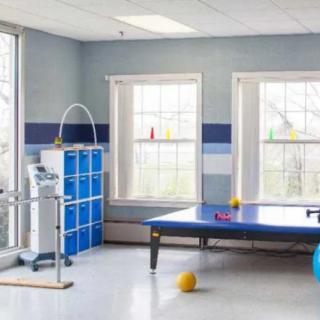 A physical therapy room equipped with exercise tables and equipment.
