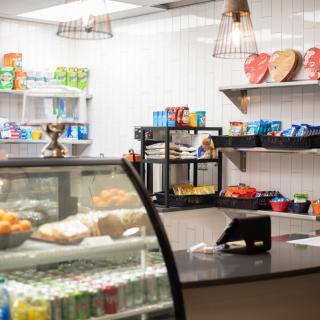 An inviting cafe counter displaying a variety of snacks and beverages.