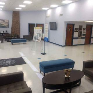A spacious lobby area with seating and a reception desk.
