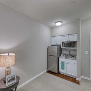 A compact, modern kitchen space in an apartment with minimalist design.