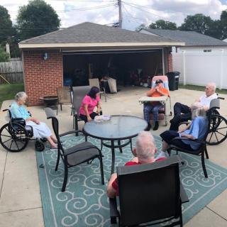 A group of elderly people enjoying a social gathering on a patio.