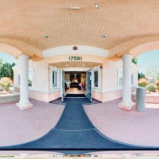 A welcoming entrance to a building with a well-maintained path and inviting atmosphere.