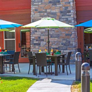 An inviting outdoor dining area with tables and colorful umbrellas.