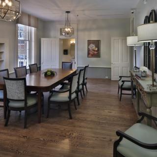 Elegant dining room with a large table, comfortable chairs, and stylish chandeliers.