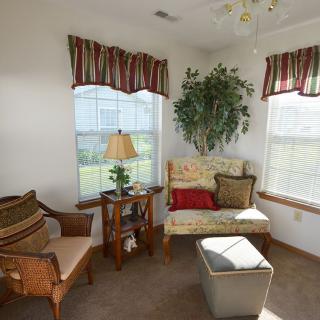 A cozy living room corner with comfortable seating and plenty of natural light.