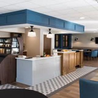 A modern cafe interior with a stylish counter and seating area.