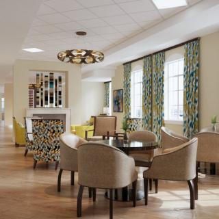 A modern dining area with stylish furniture and decorative lighting.