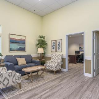 A well-decorated waiting room with comfortable seating and decor.