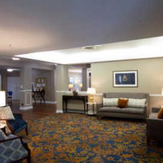 A spacious lobby with comfortable seating and warm lighting.