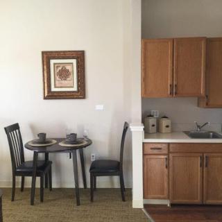 A small kitchen with a dining table set for two.