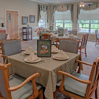 A beautifully set dining room with elegantly arranged tables and chairs.
