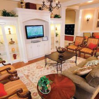 A cozy living room with elegant decor and a television mounted on the wall.