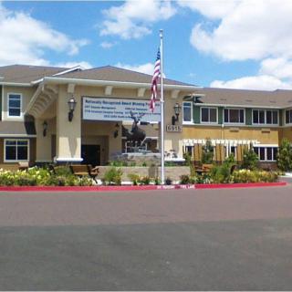A residential building with an American flag at the entrance.