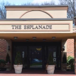 Entrance to The Esplanade building with a prominent sign.