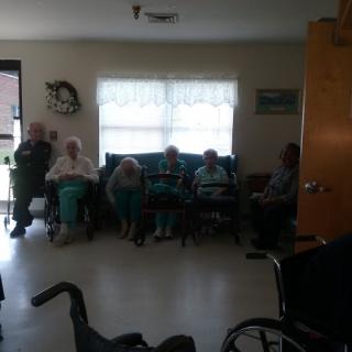 A group of elderly individuals seated together in a communal space.