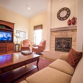 A cozy living room featuring a fireplace, sofa, and television.