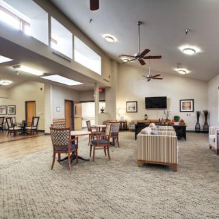 A spacious and well-lit living room with comfortable seating and modern amenities.