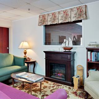 A cozy living room featuring a fireplace, comfortable seating, and decorative accents.