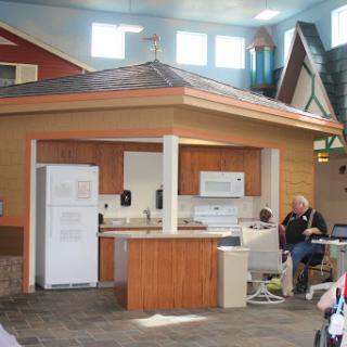 A model kitchen setup showcasing various appliances in a home construction environment.
