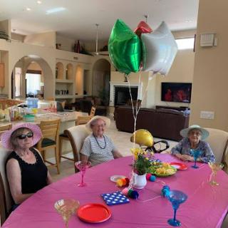 A joyful gathering around a decorated table, celebrating with family and friends.