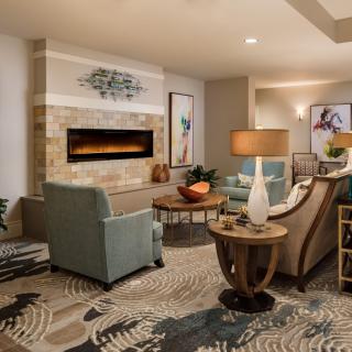 A modern living room with a cozy fireplace, stylish furniture, and elegant decor.
