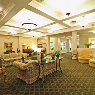 A spacious and elegant lobby area with comfortable seating and warm lighting.