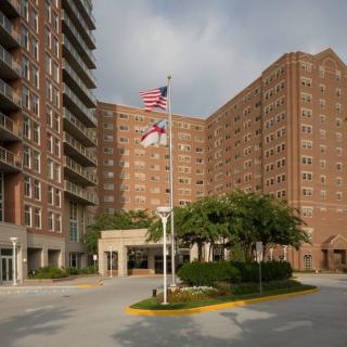 A large residential apartment complex with flags near the entrance.
