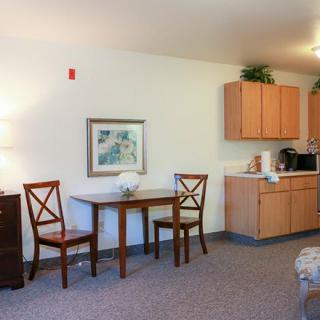 A cozy living area with a small dining table and kitchenette.