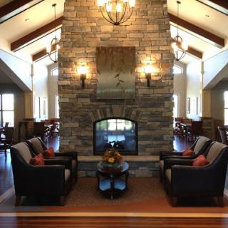 A cozy living room featuring a stone fireplace and comfortable seating, perfect for relaxation.