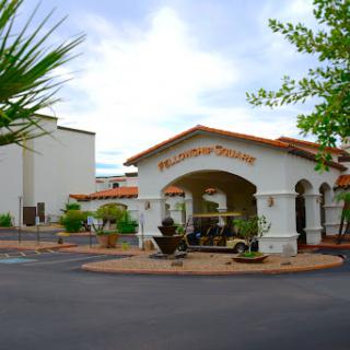 The welcoming entrance of a hotel featuring Mediterranean-style architecture.