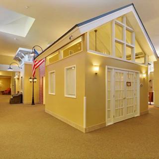 A scaled-down house model displayed indoors, showcasing architectural design.