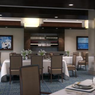 A cozy dining area featuring elegantly set tables and wine display.