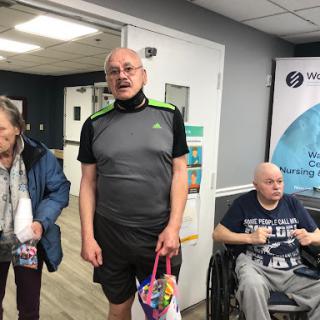 A group of individuals interacting in a healthcare facility.