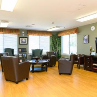 A cozy waiting area featuring comfortable chairs and a coffee table.