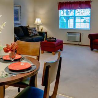 A cozy living room with dining area set up, featuring comfortable seating and tasteful decor.