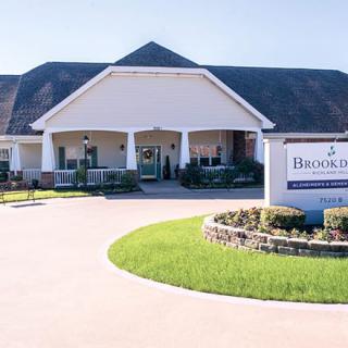 A large building with a welcoming entrance and a sign indicating the name of the facility.