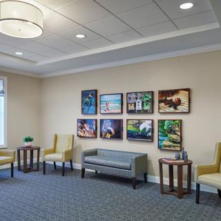 A well-designed waiting room featuring comfortable seating and vibrant artwork.
