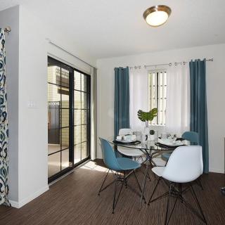 A modern dining room with natural light and contemporary furniture.