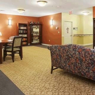 A cozy lounge area with comfortable seating and a bookshelf.